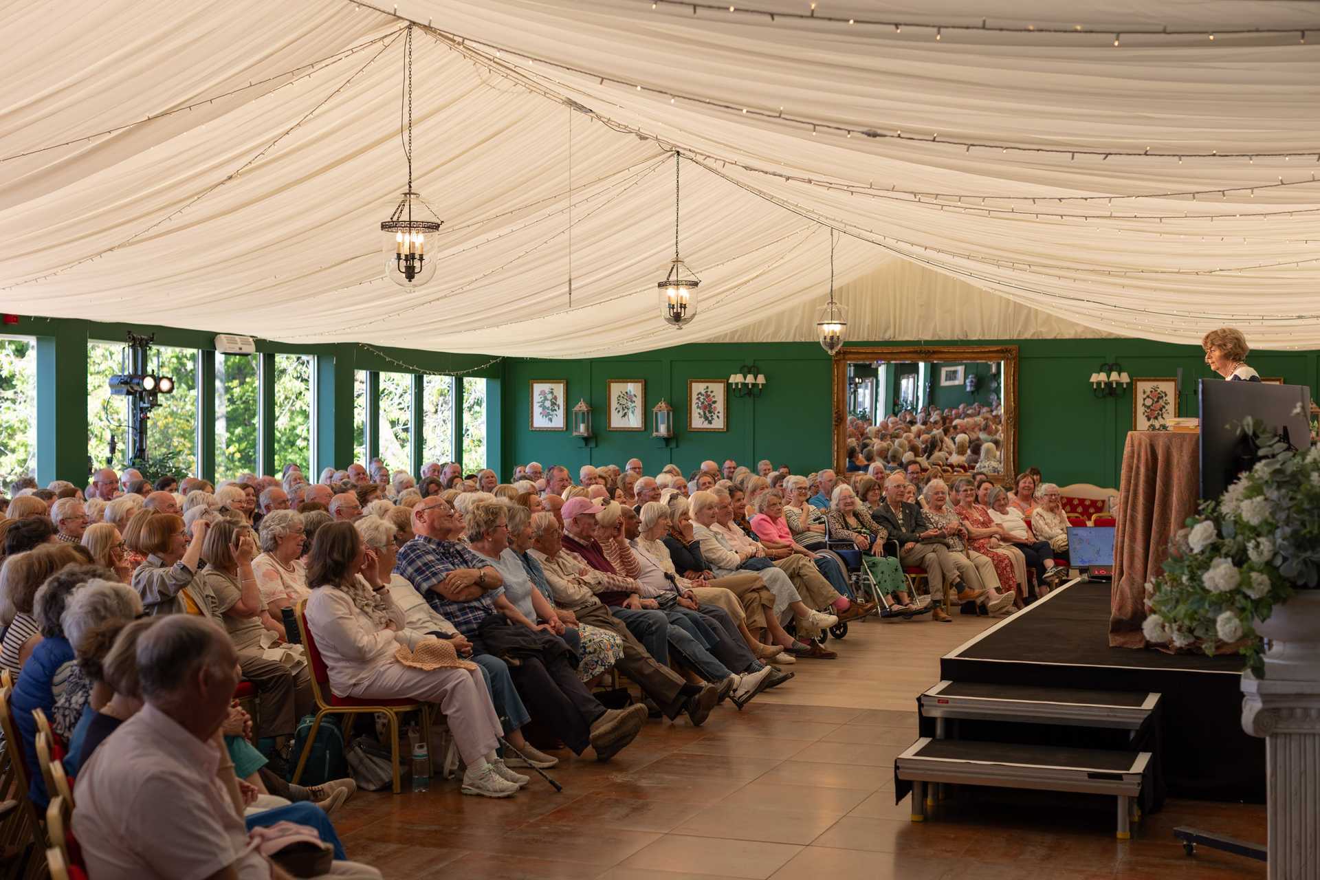People walking in front of the Boswell Book Festival banner